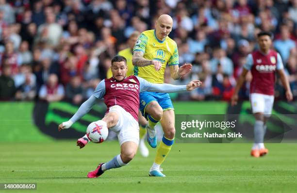 Emi Buendia of Aston Villa is challenged by Jonjo Shelvey of Nottingham Forest during the Premier League match between Aston Villa and Nottingham...