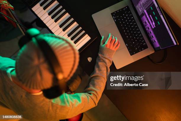 an unrecognizable male musician using the computer - man at piano alone stock pictures, royalty-free photos & images