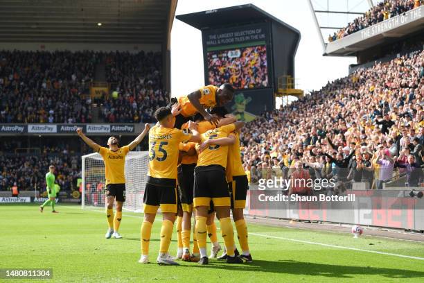 Matheus Nunes of Wolverhampton Wanderers celebrates with teammates after scoring the team's first goal during the Premier League match between...