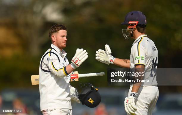 Alex Davies of Warwickshire celebrates their century with team mate Sam Hain during Day Three of the LV= Insurance County Championship Division 1...