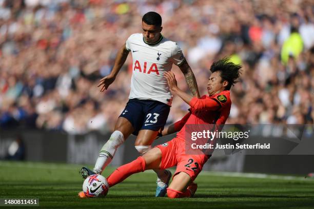 Pedro Porro of Tottenham Hotspur is challenged by Kaoru Mitoma of Brighton & Hove Albion during the Premier League match between Tottenham Hotspur...