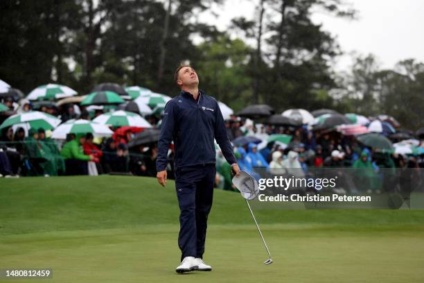 Justin Thomas of the United States reacts to his bogey on the 18th green during the continuation of the weather delayed second round of the 2023...