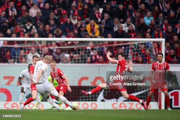 Matthijs de Ligt of Bayern Munich scores their sides first goal during the Bundesliga match between Sport-Club Freiburg and FC Bayern München at...