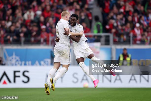 Matthijs de Ligt of Bayern Munich celebrates with team mate Alphonso Davies of Bayern Munich after scoring their sides first goal during the...