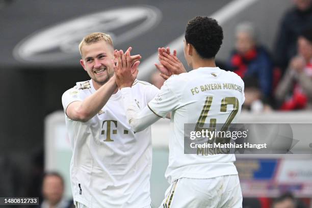 Matthijs de Ligt of Bayern Munich celebrates with team mate Jamal Musiala after scoring their sides first goal during the Bundesliga match between...