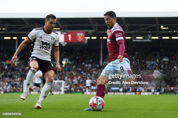 Cedric Soares of Fulham battles for possession with Pablo Fornals of West Ham United during the Premier League match between Fulham FC and West Ham...
