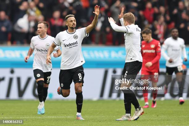 Djibril Sow celebrates with Kristijan Jakic of Eintracht Frankfurt after scoring the team's first goal during the Bundesliga match between Bayer 04...