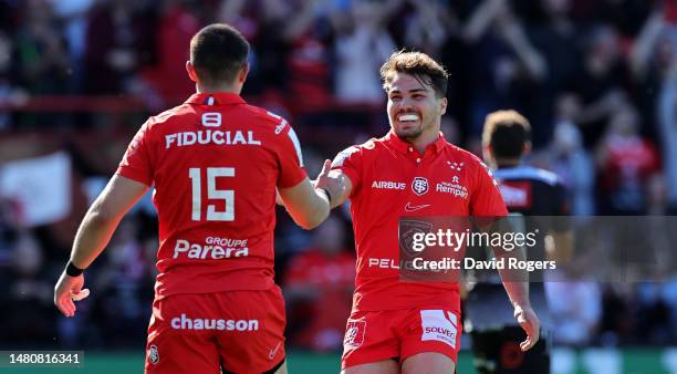 Thomas Ramos of Toulouse is congratulated by team captain, Antoine Dupont after their second try during the Heineken Champions Cup match between...