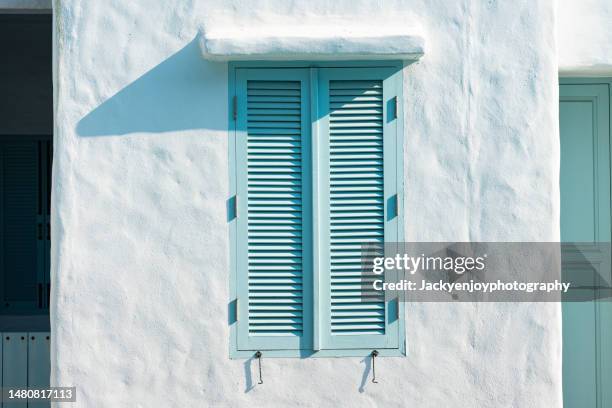 view of blue window on white wall - opening shutter stock pictures, royalty-free photos & images