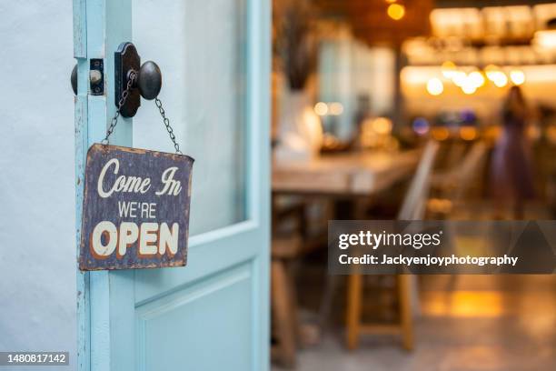 open sign on cafe hang on door at entrance. - small placard stock pictures, royalty-free photos & images