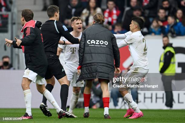 Joshua Kimmich of Bayern Munich clashes with players of SC Freiburg at the final whistle during the Bundesliga match between Sport-Club Freiburg and...