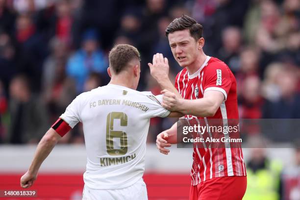 Joshua Kimmich of Bayern Munich clashes with Michael Gregoritsch of SC Freiburg after the Bundesliga match between Sport-Club Freiburg and FC Bayern...