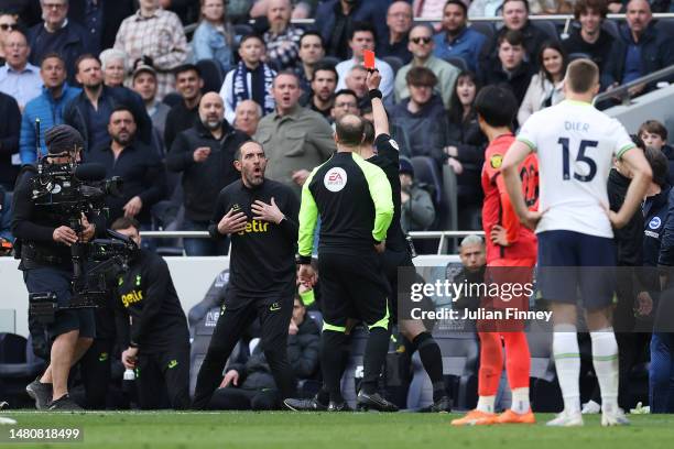 Referee Stuart Attwell shows a red card to Cristian Stellini, Interim Manager of Tottenham Hotspur, during the Premier League match between Tottenham...