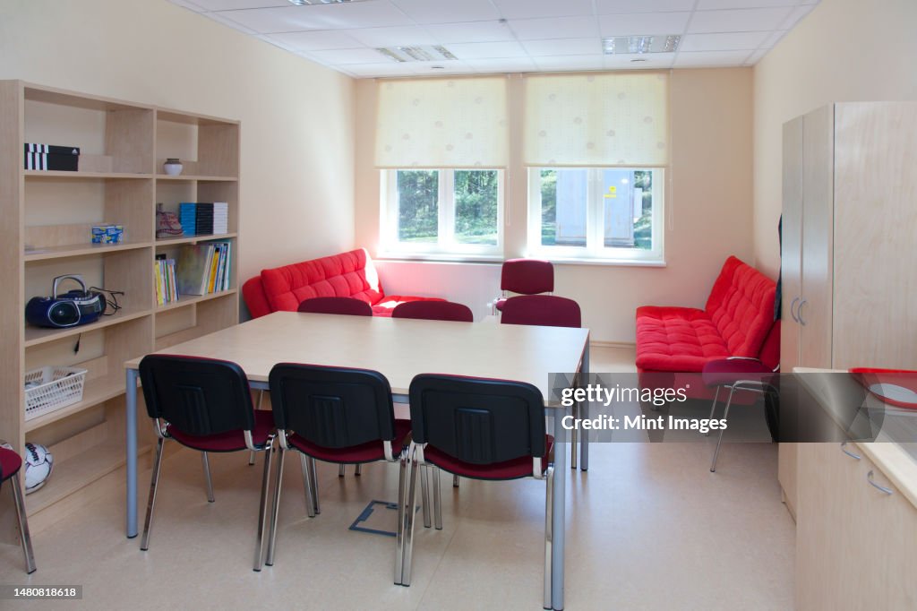 A school staff room or teacher's room, a rest room with sofa and chairs