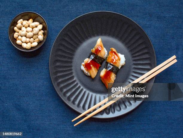 a blue plate with fresh fish and seaweed - tray stock pictures, royalty-free photos & images