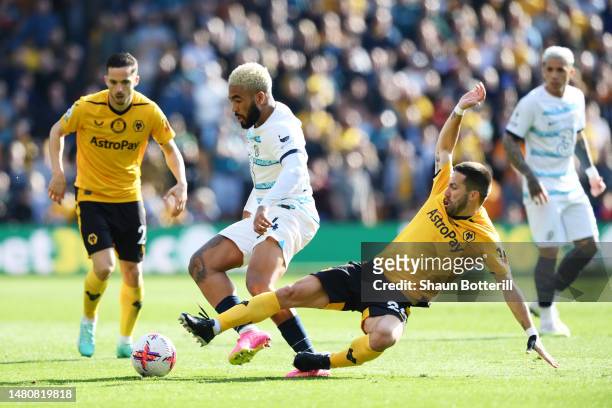 Reece James of Chelsea is challenged by Joao Moutinho of Wolverhampton Wanderers during the Premier League match between Wolverhampton Wanderers and...