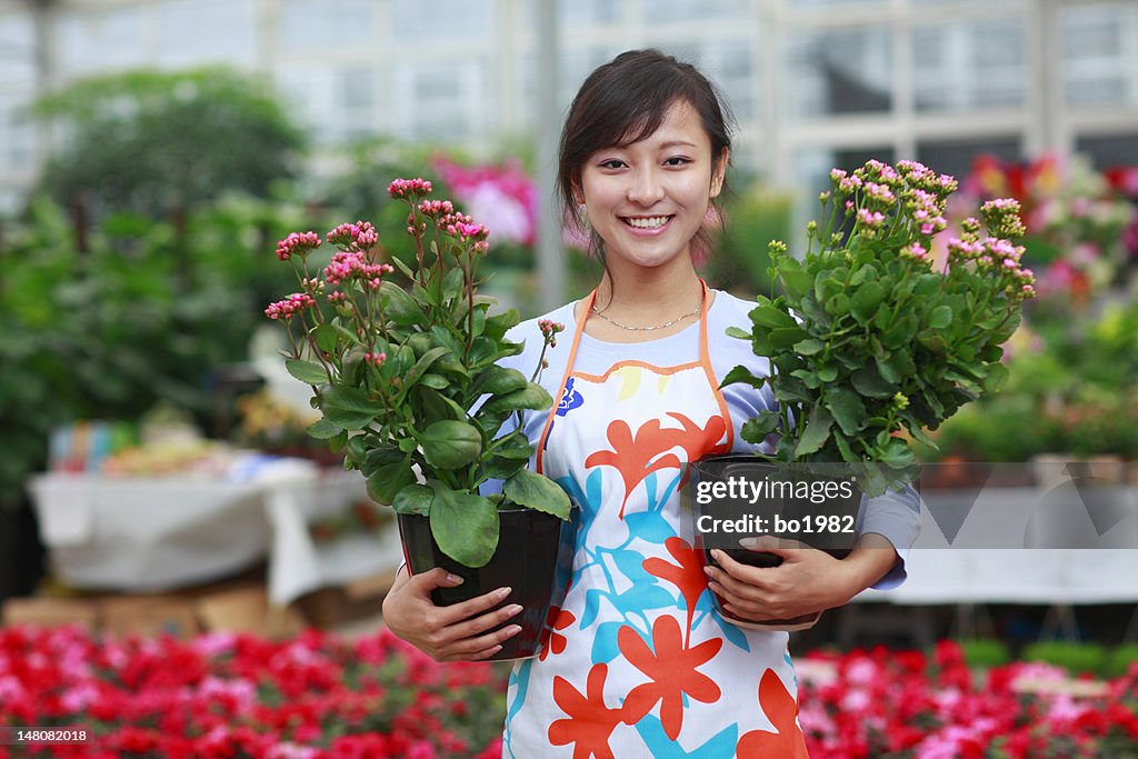 Picture of young asian florist in her shop