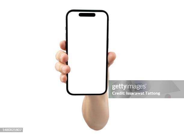 woman holding emty screen mobile phone studio shot isolated on white background - auf sich zeigen stock-fotos und bilder