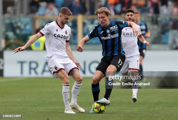 Rasmus Hojlund of Atalanta BC battles for possession with Stefan Posch of Bologna FC during the Serie A match between Atalanta BC and Bologna FC at...