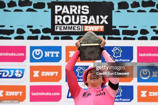 Alison Jackson of Canada and Team EF Education-Tibco-Svb celebrates at podium as race winner with the cobblestone-race-trophy during the 3rd...