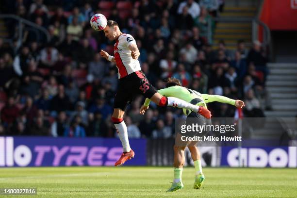 Jan Bednarek of Southampton jumps for the ball with Jack Grealish of Manchester City during the Premier League match between Southampton FC and...