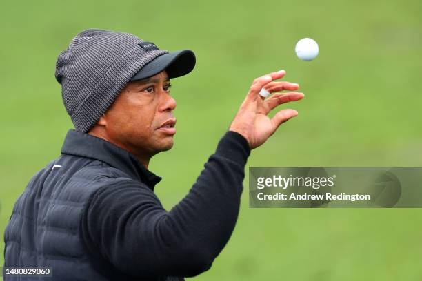 Tiger Woods of the United States catches a ball on the practice area during the third round of the 2023 Masters Tournament at Augusta National Golf...