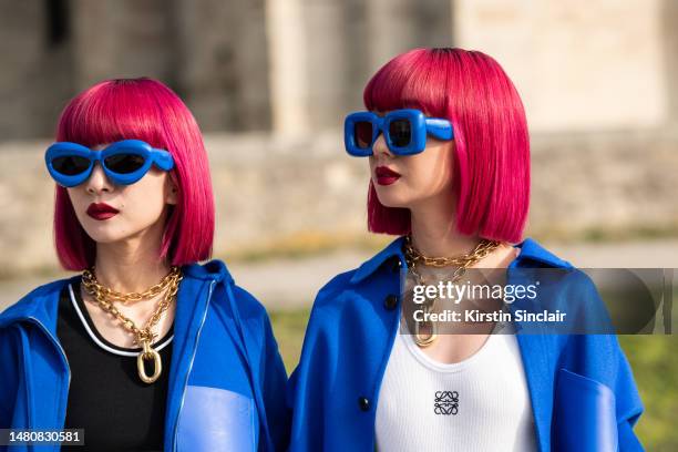 Ami Amiaya and Aya Amiaya wear all Loewe with Paco Rabanne necklaces outside the Loewe show on March 03, 2023 in Paris, France.