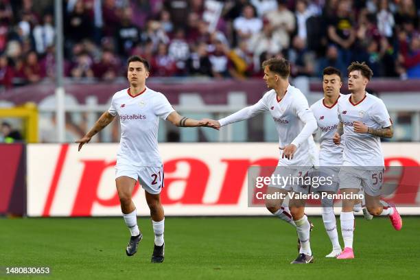 Paulo Dybala of AS Roma celebrates with teammate Diego Llorente after scoring the team's first goal during the Serie A match between Torino FC and AS...