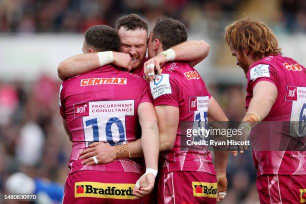Tom Wyatt of Exeter Chiefs celebrates scoring the team's first try with teammates Joe Simmonds and Sam Simmonds during the Heineken Champions Cup...