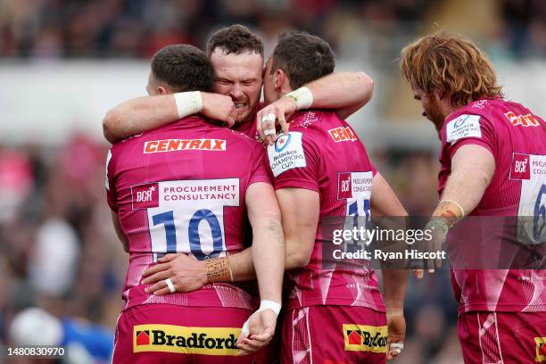 Tom Wyatt of Exeter Chiefs celebrates scoring the team's first try with teammates Joe Simmonds and Sam Simmonds during the Heineken Champions Cup...