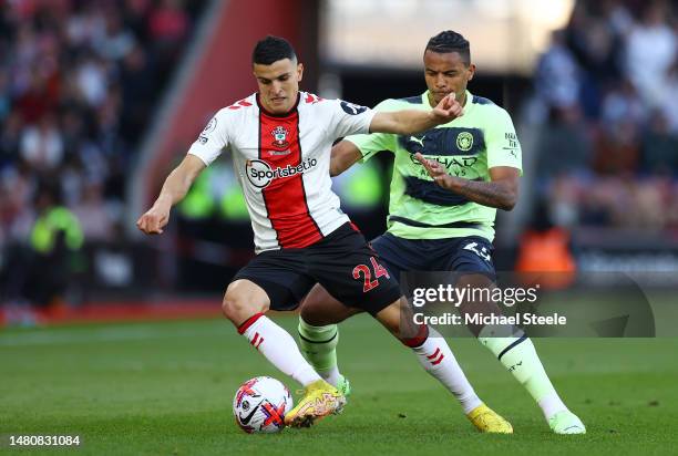 Mohamed Elyounoussi of Southampton is challenged by Manuel Akanji of Manchester City during the Premier League match between Southampton FC and...