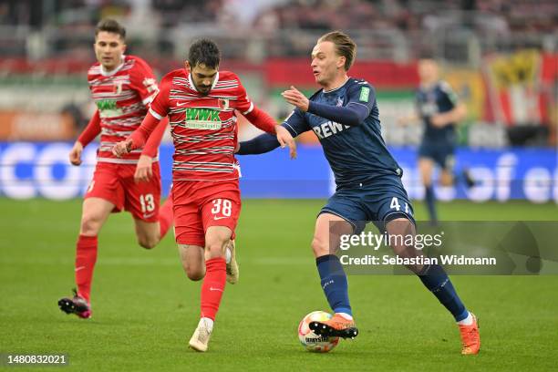 David Colina of FC Augsburg and Mathias Flaga Olesen of 1.FC Köln compete for the ball during the Bundesliga match between FC Augsburg and 1. FC Köln...