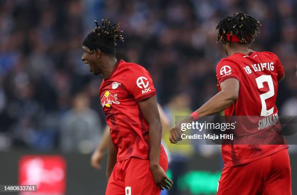 Mohamed Simakan of RB Leipzig celebrates with team mate Amadou Haidara after scoring their sides first goal during the Bundesliga match between...