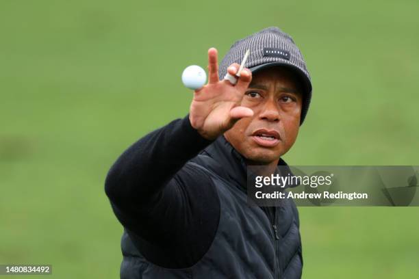 Tiger Woods of the United States catches a ball on the practice area during the third round of the 2023 Masters Tournament at Augusta National Golf...