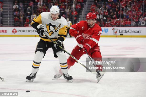 Evgeni Malkin of the Pittsburgh Penguins tries to get around the stick of Dylan Larkin of the Detroit Red Wings during the first period at Little...