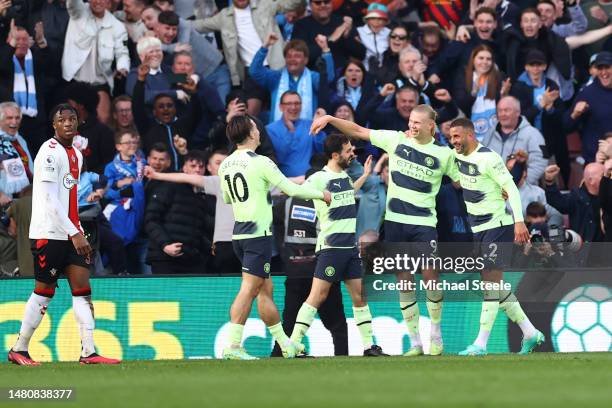 Erling Haaland of Manchester City celebrates with teammates after scoring the team's third goal during the Premier League match between Southampton...