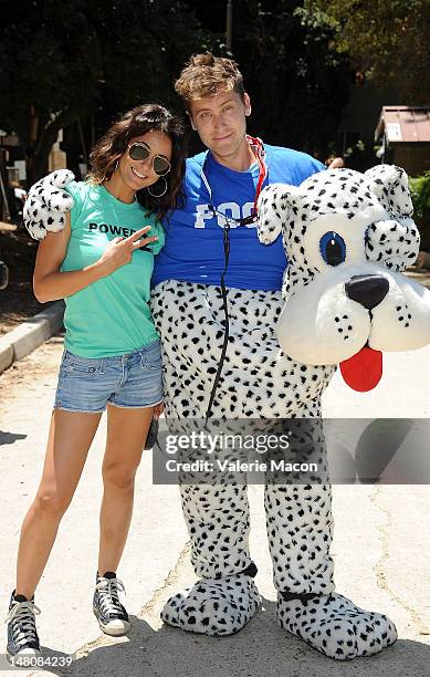 Actress Emmanuelle Chriqui walks actor Lance Bass dressed up as Poo Fu the dog in Runyon Canyon during The Power Of 2 Event on July 9, 2012 in Los...