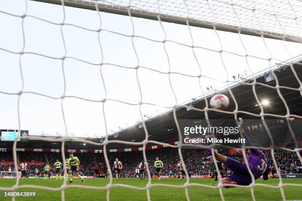 Julian Alvarez of Manchester City scores the team's fourth goal from the penalty spot past Gavin Bazunu of Southampton during the Premier League...