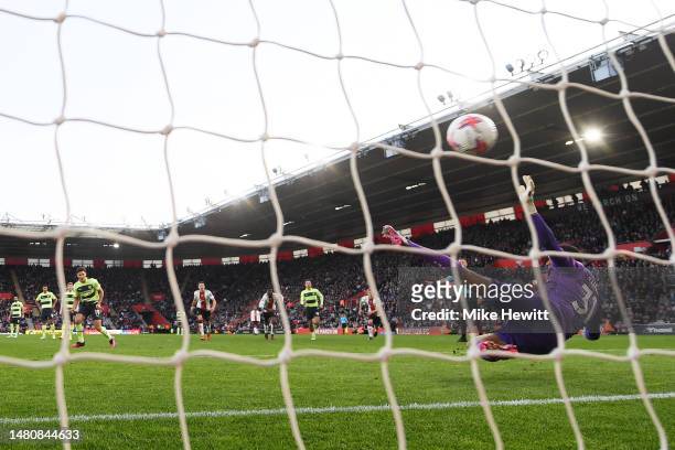 Julian Alvarez of Manchester City scores the team's fourth goal from the penalty spot past Gavin Bazunu of Southampton during the Premier League...