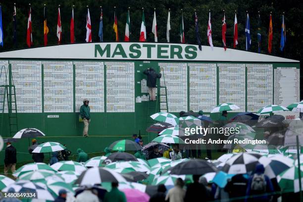 Patrons evacuate the grounds after play was suspended for the day dueritduring the third round of the 2023 Masters Tournament at Augusta National...