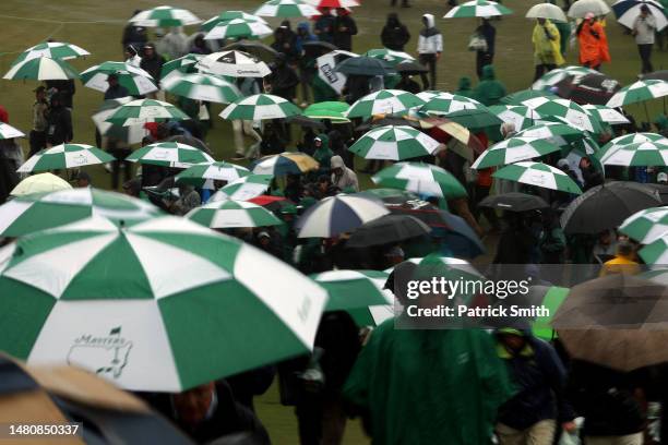 Patrons evacuate the grounds after play was suspended for the day due to weather conditions during the third round of the 2023 Masters Tournament at...