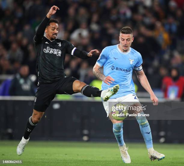 Sergej Milinkovic-Savic of SS Lazio is challenged by Danilo of Juventus during the Serie A match between SS Lazio and Juventus at Stadio Olimpico on...