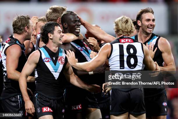 Aliir Aliir of Port Adelaide celebrates with team mates at full time during the round four AFL match between Sydney Swans and Port Adelaide Power at...
