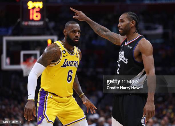 Kawhi Leonard of the LA Clippers directs a play in front of LeBron James of the Los Angeles Lakers during a 125-118 Clippers win at Crypto.com Arena...