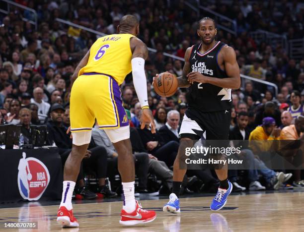 Kawhi Leonard of the LA Clippers drives to the basket on LeBron James of the Los Angeles Lakers during a 125-118 Clippers win at Crypto.com Arena on...