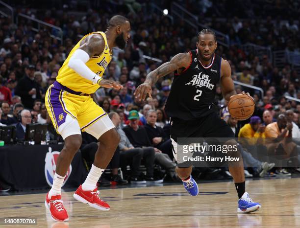Kawhi Leonard of the LA Clippers drives to the basket on LeBron James of the Los Angeles Lakers during a 125-118 Clippers win at Crypto.com Arena on...