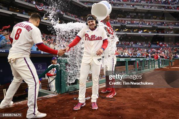 Nick Castellanos, Bryson Stott and Kyle Schwarber of the Philadelphia Phillies react after defeating the Cincinnati Reds at Citizens Bank Park on...