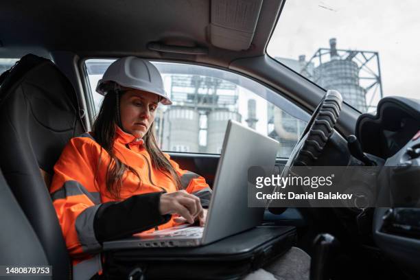 woman engineer working from car at power plant. - automobile production at the seat factory stock pictures, royalty-free photos & images