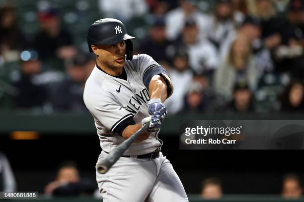 Giancarlo Stanton of the New York Yankees hits a second inning single against the Baltimore Orioles at Oriole Park at Camden Yards on April 08, 2023...