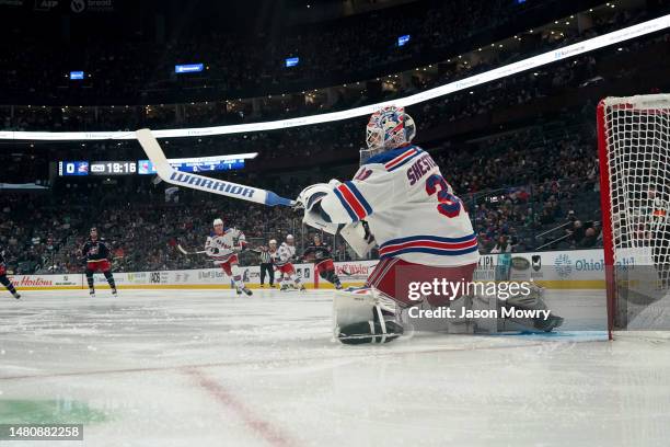 Igor Shesterkin of the New York Rangers knocks the puck out of the air with his stick during the second period of the game against the Columbus Blue...